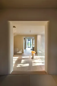 Modern entryway featuring wood flooring and concrete walls.