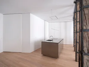 A modern kitchen featuring a minimalist design with a steel countertop.