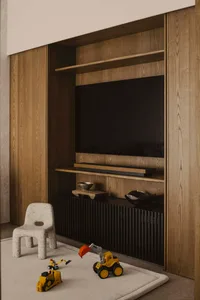A minimalist children's room featuring a dark wood and metal entertainment center, with a small white plastic chair and toy t