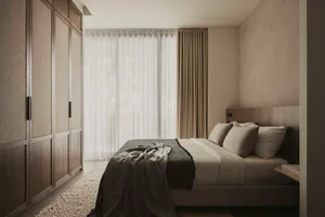 Minimalist bedroom featuring transparent window, wooden furniture, and beige fabrics.