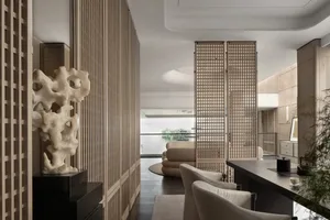 A minimalist living room featuring wooden paneling and modern furniture.