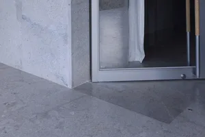 A sleek, modern interior space featuring a concrete floor and minimalist design.