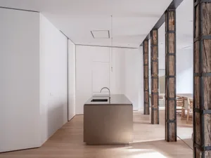 Modern kitchen interior featuring a metal countertop and minimalist design elements.