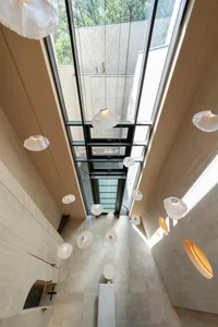 Modern interior featuring contemporary lighting fixtures and concrete finishes.