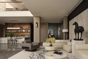 Modern living room featuring a bar area with marble countertops, a stylish sofa, and a horse statue.