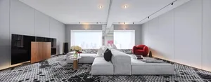 Modern living room with grey sofa, black and white patterned rug, large windows, and cityscape view.
