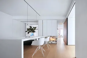 Modern living room featuring marble elements and white furniture.