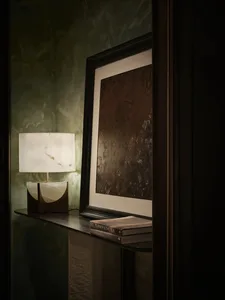 A sleek, modern bedside table made of marble with a minimalist design.