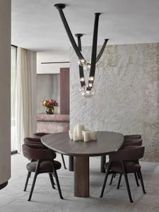 Contemporary dining room featuring wooden furniture and lighting with a modern aesthetic.