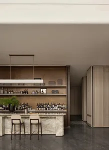 Modern bar with a marble counter featuring a variety of bottles and glasses.