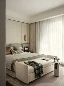 Minimalist bedroom featuring modern furniture and neutral color palette.