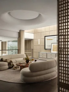 A modern living room with neutral-toned furniture and minimalist design.