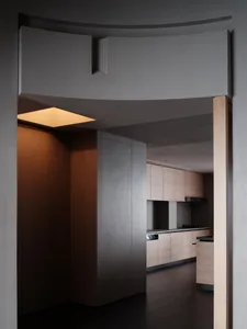 Modern kitchen with wooden cabinets and a minimalist design.