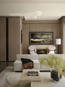 Modern living room with white and beige tones, featuring a minimalist white couch, white chairs, a marble coffee table, and a