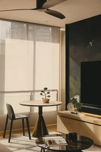 Modern minimalist living room featuring sleek marble and metallic finishes.