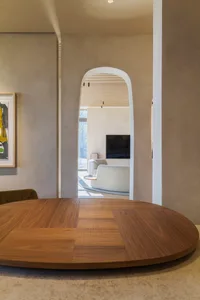 A well-designed minimalist living room with wooden furniture and a white sofa.