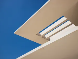 Modern architectural detail featuring concrete lines and open sky.