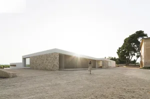 A rendering of a modern building made of stone with wooden accents.