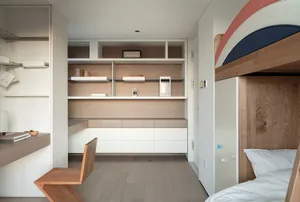 Modern minimalist bedroom featuring wooden furniture and white accents.