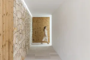 A modern corridor with a stone wall