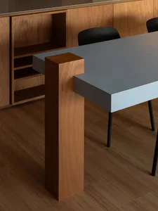 Modern dining room featuring a sleek table with wood and steel legs.