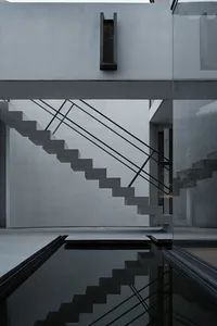 A minimalist modern interior design featuring a concrete staircase.