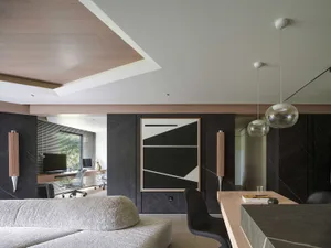 A modern living room featuring stone walls and a minimalist design.