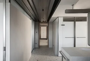 A modern, minimalist bathroom with concrete walls and floors, featuring sleek white fixtures and a clean, uncluttered design.