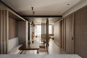 Modern minimalist dining room with wooden furniture and white accents, featuring a live edge dining table and built-in seatin