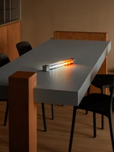 Minimalist office table with clear acrylic blocks and wooden accents, featuring LED lighting.