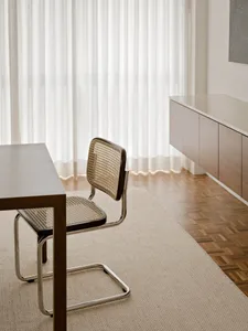 Modern home office featuring a sleek, dark wood desk and minimalist chair