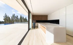 Modern interior design featuring wood, glass, and marble materials.