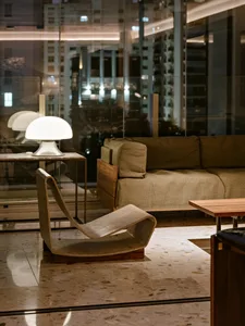 Modern living room with a wooden sofa, lamp, and coffee table.
