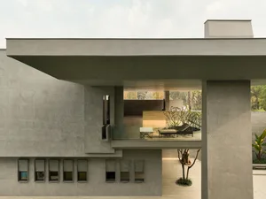 Modern, minimalist architectural design featuring concrete materials and geometric shapes.