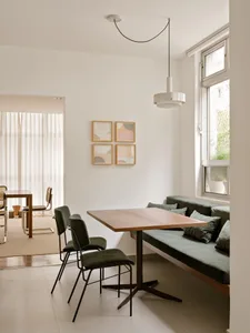 Modern dining room with a wooden table and cushion seating