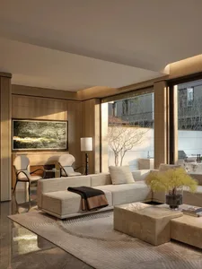 Modern living room featuring a comfortable white couch with textured fabric, centered under a large window with a view of a s
