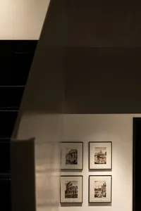 Four framed artworks depicting historical Roman landmarks hanging on a wall in an art museum.