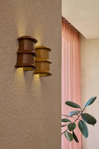 A ceramic wall light fixture with a rustic appearance.