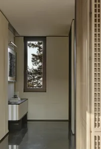 Minimalist corridor with wood walls and a tall window, showcasing a serene and modern atmosphere