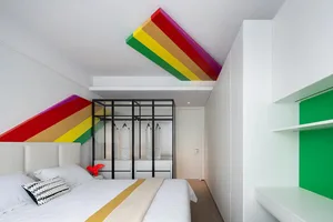 Modern bedroom with white walls, colorful ceiling accents, and a glass-door wardrobe.