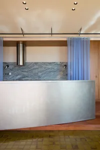 A modern interior design featuring stainless steel and granite materials.