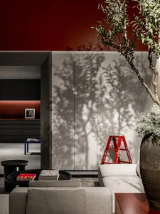 Modern living room featuring metallic cabinetry, concrete flooring, and a fabric sofa.