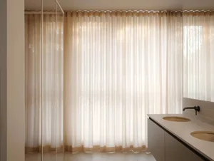 A minimalist bathroom featuring elegant linen curtains.
