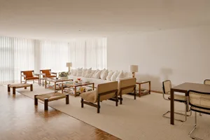 A minimalist living space featuring wood and wool materials.