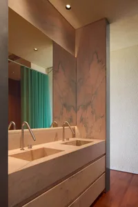 Contemporary bathroom design featuring sleek marble sinks and minimalist fixtures.