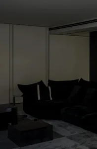 Modern living room with a black fabric sofa and minimalist decor.