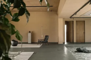 A modern living room featuring a concrete floor and minimalist design