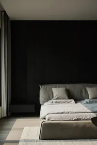 A modern minimalist bedroom with textured wooden walls and fabric bedding.