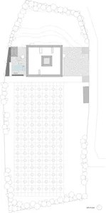2D architectural drawing of a building site with lines, shapes, and annotations indicating different areas and elements.