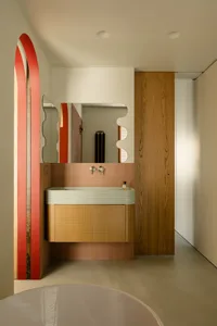 Industrial-style bathroom featuring wooden accents, ceramic tiles, and a textured meta carpet